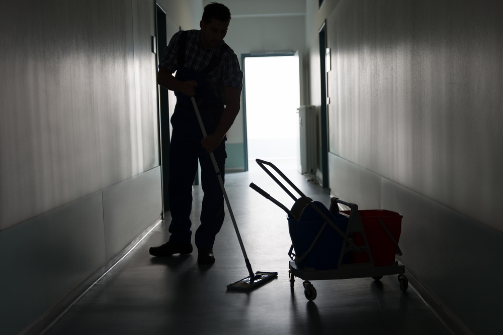 Man With Broom Cleaning Office Corridor Property Management Janitorial Services Naples